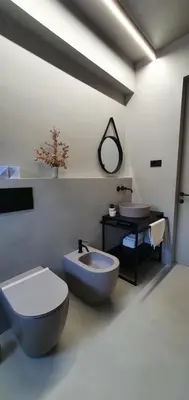 a bathroom with a toilet and a tub and a sink at HOUSE G in Dekani