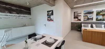 a kitchen with white walls and a white table at HOUSE G in Dekani
