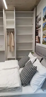 a bed with pillows on it in a bedroom at HOUSE G in Dekani