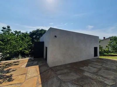 a large concrete building with a door on a patio at HOUSE G in Dekani