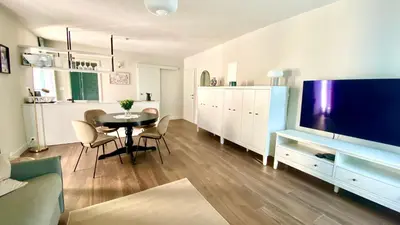 a living room with a table and a big screen tv at Aria Apartments in Kojsko
