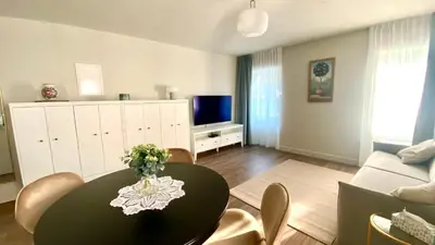 a living room with a table and a couch at Aria Apartments in Kojsko
