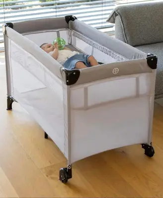 a baby in a crib in a room at APARTMENt ANAYA in Bovec