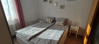 a small bed in a small room with a window at Apartma Vila Kočna in Zgornje Jezersko