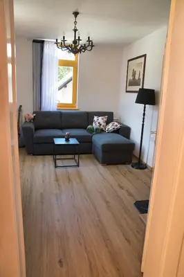 a living room with a couch and a table at Apartma Vila Kočna in Zgornje Jezersko