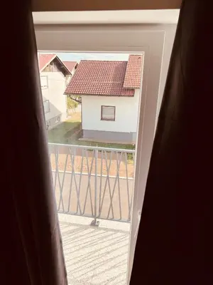 a view from an open window of a house at PJagodic Hotel Cerklje - 5min to Airport - Free Parking in Cerklje na Gorenjskem