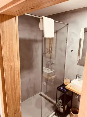 a shower with a glass door in a bathroom at PJagodic Hotel Cerklje - 5min to Airport - Free Parking in Cerklje na Gorenjskem