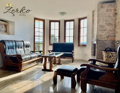 a living room with a couch and a table at Zerko Holiday Home - Vineyard Chalet With Sauna and Jacuzzi FREE in Mirna