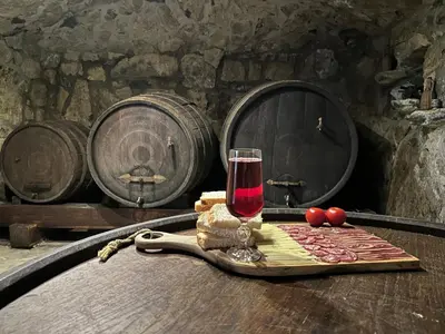 a glass of wine sitting on top of a table at Zerko Holiday Home - Vineyard Chalet With Sauna and Jacuzzi FREE in Mirna