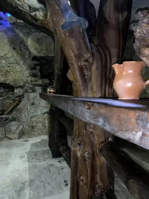 a vase sitting on top of a wooden table at Zerko Holiday Home - Vineyard Chalet With Sauna and Jacuzzi FREE in Mirna
