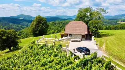 a car parked in front of a barn in a vineyard at Zerko Holiday Home - Vineyard Chalet With Sauna and Jacuzzi FREE in Mirna