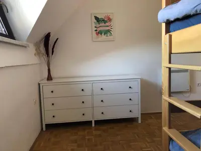 a bedroom with a dresser and a bunk bed at Spa House Lotus in Terme Čatež in Čatež ob Savi