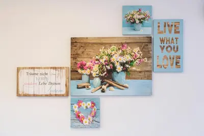a group of pictures on a wall with flowers in vases at Apartments Mirela in Koper