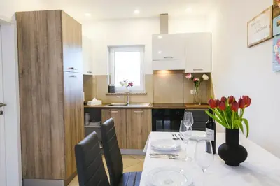 a kitchen with a table and a dining room at Apartments Mirela in Koper