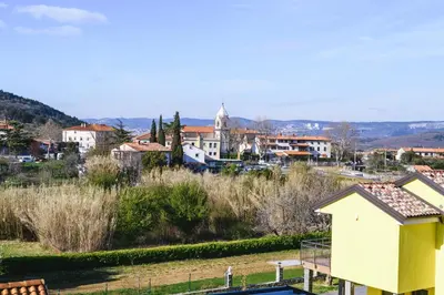 a view of a town with a yellow building at Apartments Mirela in Koper