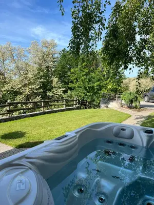 a pool of water in front of a yard at Vineyard cottage Skriti raj in Leskovec pri Krškem