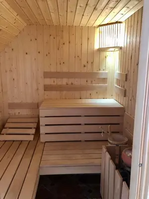 a sauna with a bench in a wooden room at Vineyard cottage Skriti raj in Leskovec pri Krškem