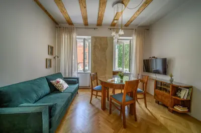 a living room with a green couch and a table at KariNatura in Ljubljana