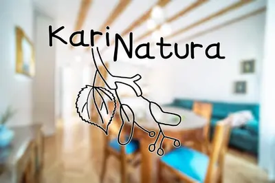 a sign that reads karma nirula in a living room at KariNatura in Ljubljana