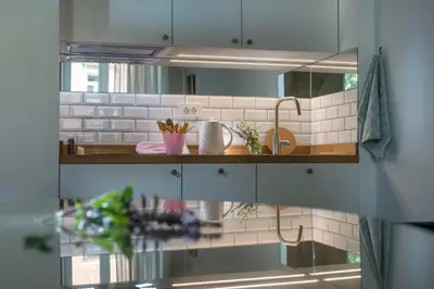 a kitchen with a sink and a mirror at KariNatura in Ljubljana