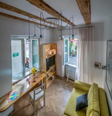 a living room with a couch and a table at KariNatura in Ljubljana