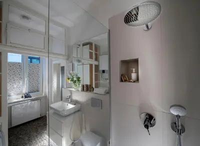 a white bathroom with a sink and a mirror at KariNatura in Ljubljana
