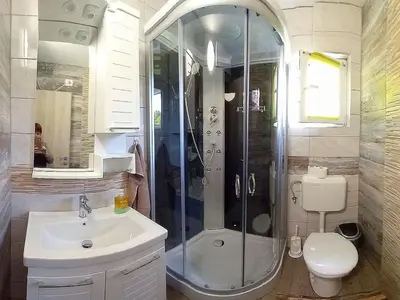a bathroom with a shower and a sink and a toilet at Krampez in Kobarid