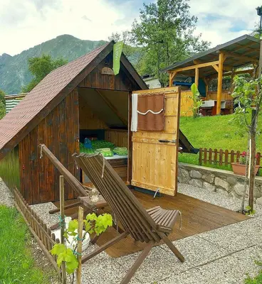 a building with a chair and a stove at Krampez in Kobarid