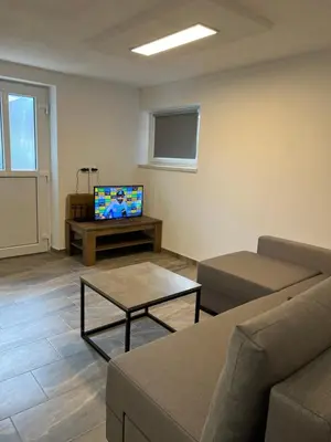 a living room with a couch and a tv at Apartma Ročica Dejan Uršič sobodajalec in Kobarid