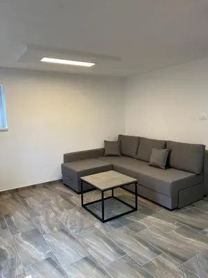 a living room with a couch and a coffee table at Apartma Ročica Dejan Uršič sobodajalec in Kobarid