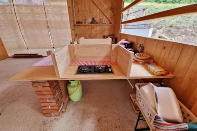 a room with a stove in a wooden room at Kamp Beli gaber in Stari Trg pri Ložu