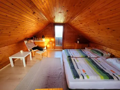 a room with a large bed in a wooden room at Chalet Panorama in Občine