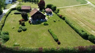 an aerial view of a small house on a grass field at Chalet Panorama in Občine