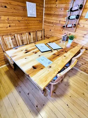 a wooden table in a room with a wooden wall at Chalet Panorama in Občine