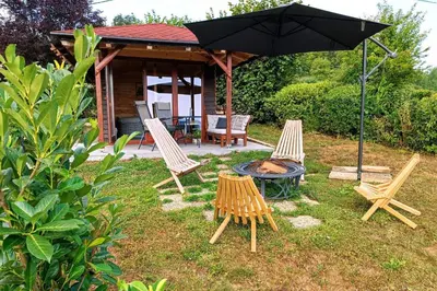 a group of chairs and a table with an umbrella at Chalet Panorama in Občine