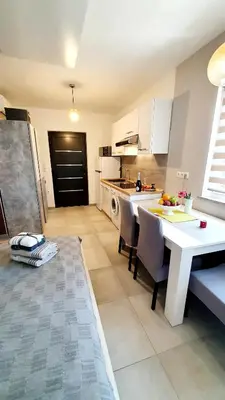 a kitchen with a table and chairs in a room at Villa Ines in Zgornje Škofije