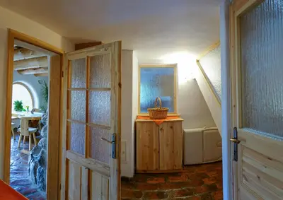 a hallway with an open door and a stairway with a table at Natur apartma Rudi in Begunje na Gorenjskem
