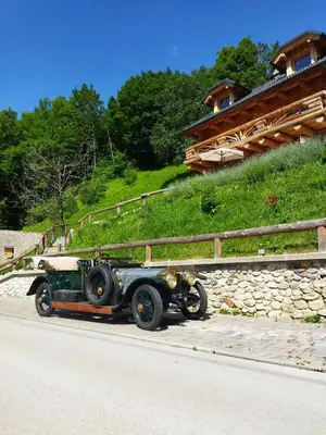 an old car parked on the side of a road at Natur apartma Rudi in Begunje na Gorenjskem