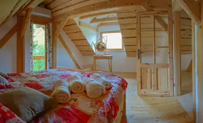 a bedroom with a bed with towels on it at Natur apartma Rudi in Begunje na Gorenjskem