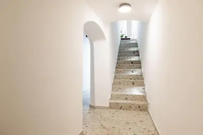a staircase in a white building with white walls at New Central Studios with parking in Ljubljana