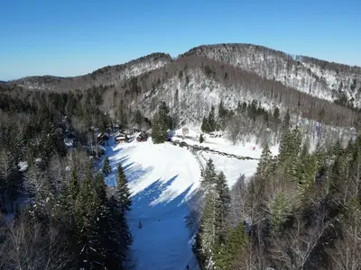 an aerial view of a ski resort in the snow at Koča Kresnica in Ilirska Bistrica