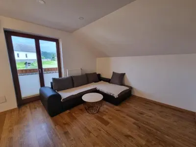 a living room with a couch and a table at Apartment 199 in Zgornje Gorje