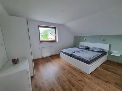 a bedroom with a bed and a window at Apartment 199 in Zgornje Gorje