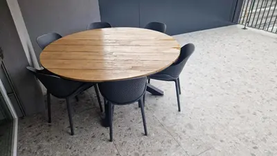 a wooden table and chairs in a room at Apartmaji PR' KERIN in Laško
