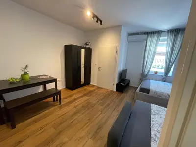 a room with a bed and a desk and a couch at Ljubljana Studios in Ljubljana