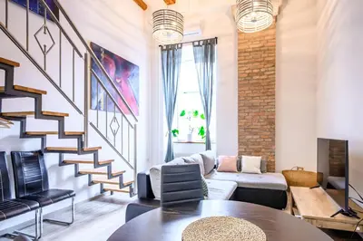 a living room with a couch and a table at The Comfortable Loft in Ljubljana