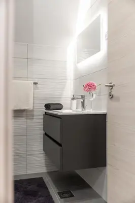 a bathroom with a sink and a mirror at Sobe in apartmaji Bama in Litija