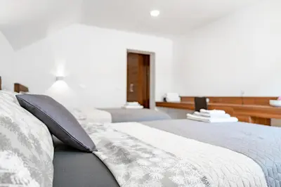 a bedroom with a bed with two pillows on it at Sobe in apartmaji Bama in Litija