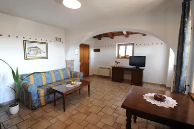 a living room with a couch and a table at Belica Bed and Breakfast in Dobrovo