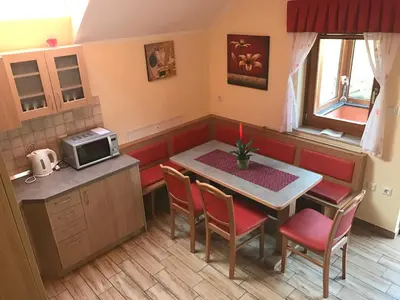 a small kitchen with a table and a microwave at Charming countryside house in Lome